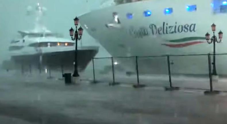 This photo grabbed from a video taken on July 7, 2019 and obtained on July 8, 2019 from Roberto Ferrucci (www.robertoferrucci.com) shows the 292-meter-long Costa Deliziosa cruise ship (right) close to a yacht (left) as it left Venice