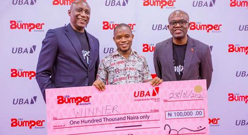  L-R: Group Head, Retail Banking, United Bank for Africa(UBA) Plc, Jude Anele; A winner in the UBA Bumper Account Promo,  Amos Wisdom; and Head Brand Management, UBA Plc, Lashe Osoba. during the launch of UBA Bumper Account and the 1st Draw of the UBA Bumper Account Promo  held in UBA House, yesterday where 100 people won N100,000 each in Lagos, on Tuesday.