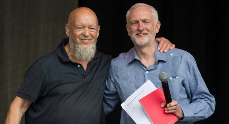 Britain's opposition Labour party leader Jeremy Corbyn (R) pictured with festival founder Michael Eavis on the Pyramid Stage at the Glastonbury Festival near the village of Pilton in Somerset, south-west England on June 24, 2017