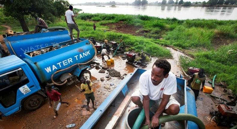 Truck drivers collect water directly from the Nile river to distribute to residents in Juba, South Sudan