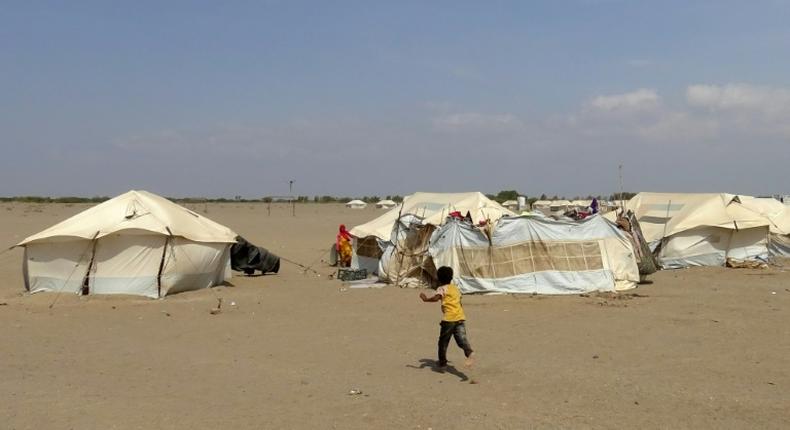 In this file photo, a Yemeni child runs toward a tent at a camp for displaced people in the Khokha district of Hodeida province on December 11, 2018