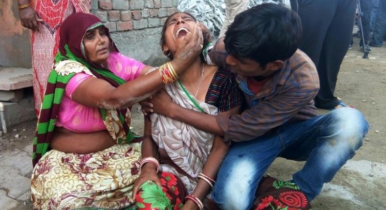 A woman cries after a wall collapsed during a wedding, killing at least 24 people, in Bharatpur, in India's Rajasthan state, on May 11, 2017