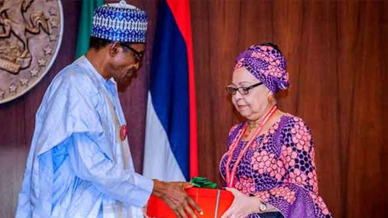 President Muhammdu Buhari receiving the report of the Tripartite Committee on the Review of National Minimum Wage from the Committee Chairman, Mrs Amal Pepple, at the State House on November 6, 2018.