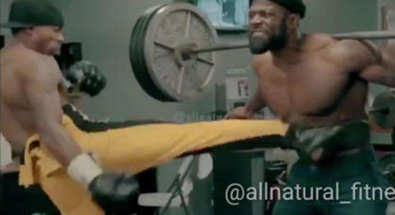 Man squats 405 pounds while other man kicks him, just for fun? 