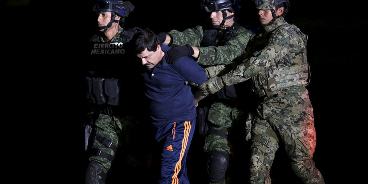 Recaptured drug lord Joaquín "El Chapo" Guzman is escorted by soldiers in Mexico City.