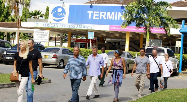 Passengers who were onboard an Air France Boeing 777 aircraft that made an emergency landing are escorted from Moi International Airport in Kenya's coastal city of Mombasa, December 20, 2015. REUTERS/Joseph Okanga