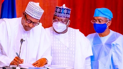 Former President Muhammadu Buhari with former Senate President Ahmad Lawan and former Speaker Femi Gbajabiamila at the signing of the Electoral Act Amendment Bill in Abuja on February 25, 2022