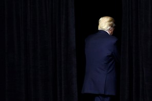 U.S. President Donald Trump exits the stage following a rally at the U.S. Cellular Center in Cedar R