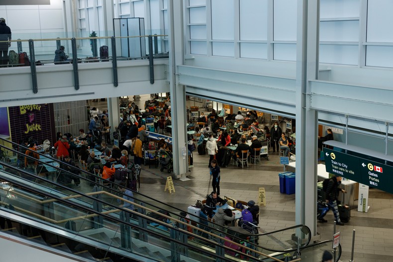 South African nationals queue at an airport in the Middle East as authorities urge citizens to leave the region amid escalating tensions between the United States, Israel and Iran. [Getty Images]