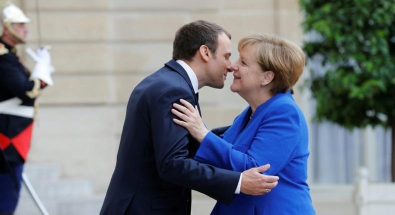 German Chancellor Angela Merkel is welcomed by French President Emmanuel Macron upon her arrival