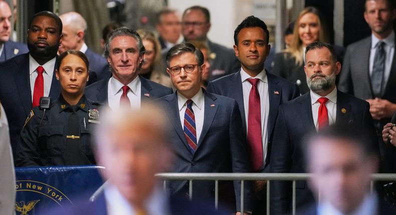 (L-R) Byron Donalds, Doug Burgum, Mike Johnson, Vivek Ramaswamy and Cory Mills listen as Donald Trump speaks to the press in the Manhattan courthouse where his hush-money trial is taking place.CURTIS MEANS/POOL/AFP via Getty Images