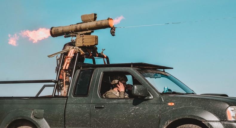 Ukrainian troops fire a wire-guided anti-tank missile from a pickup truck in May 2022.