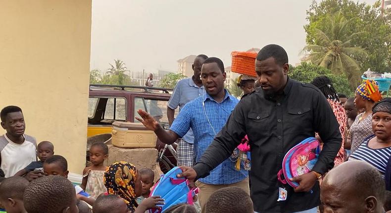 John Dumelo donates hundreds of school bags, exercise books to kids