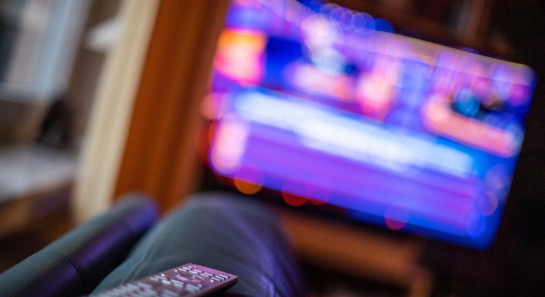 ILLUSTRATION - 04 March 2022, North Rhine-Westphalia, Bad Oeynhausen: A remote control is lying on the edge of a sofa. Photo: Lino Mirgeler/dpa