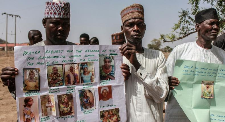 Parents and relatives hold portraits of their girls during a commemoration five years after they were abducted by Boko Haram Jihadists who stormed the Chibok girls' boarding school