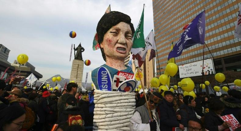 Protesters carry an effigy of South Korea's President Park Geun-Hye during a rally in Seoul, on December 3, 2016