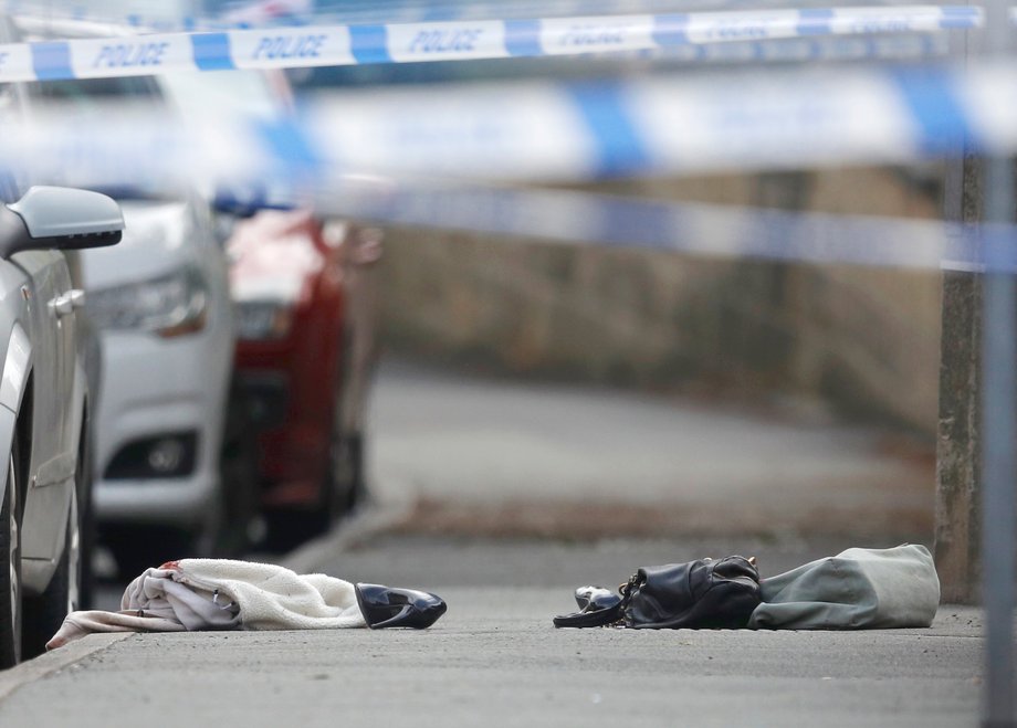 Women's shoes and a handbag lie on the ground behind a police cordon in Birstall near Leeds, June 16, 2016.