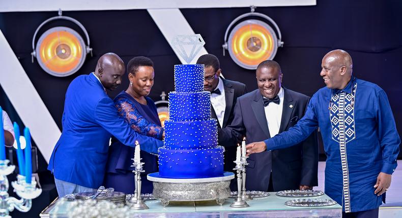dfcu Bank management, and Guest of honor cutting cake during dfcu bank's 60 year anniverssary celebrations at Mestil Hotel