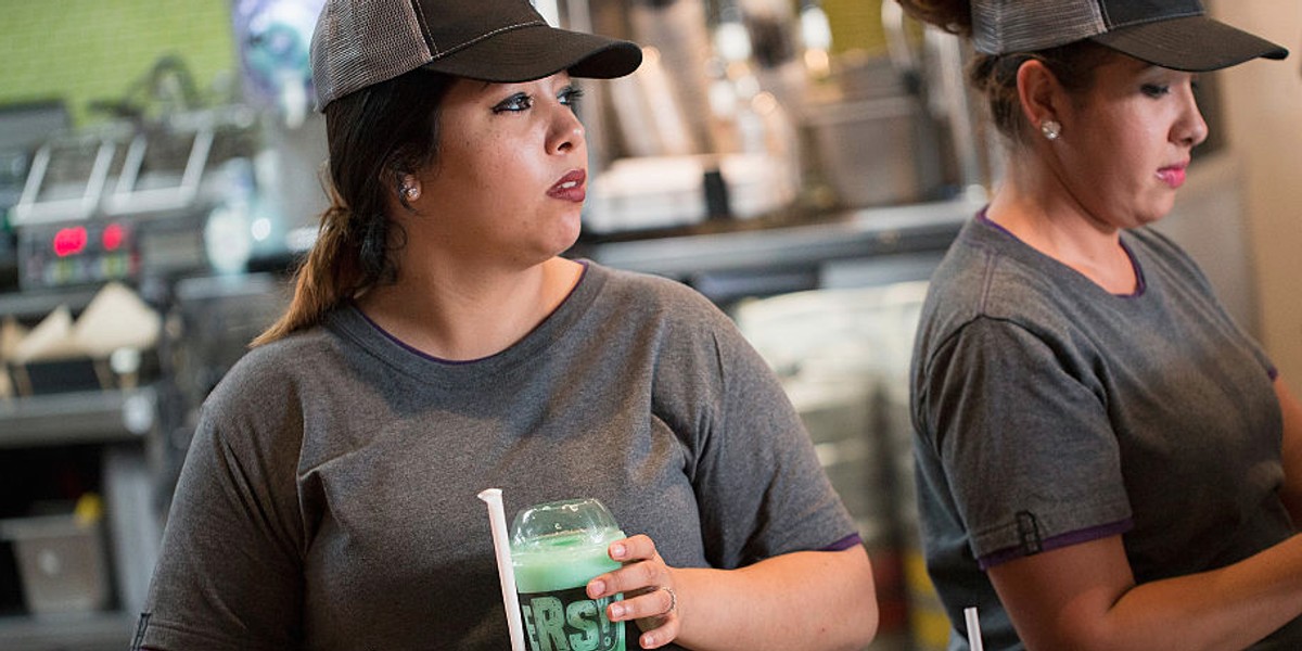 A worker serves a twisted Freeze at a Taco Bell Cantina restaurant on September 22, 2015 in Chicago, Illinois.