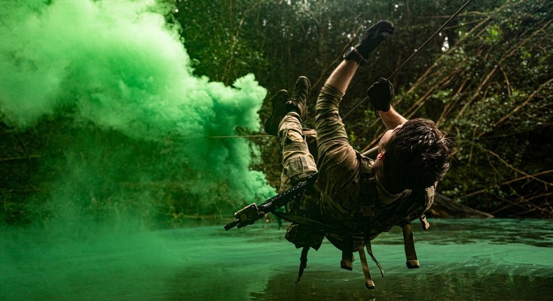 A US Air Force pararescuemen crosses a waterway using a rope system during jungle warfare training in Wahiawa, Hawaii, April 1, 2022.