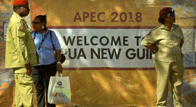 Security officials stand outside a perimeter fence for a secured area ahead of the APEC Economic Leaders' Week Summit in Port Moresby, Papua New Guinea, Wednesday, Nov. 14, 2018.