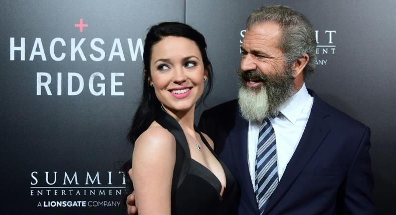 Mel Gibson and his girlfriend Rosalind Ross pose on the carpet on arrival for the special screening of the film he directed, Hacksaw Ridge, at the Samuel Goldwyn Theater in Beverly Hills, California on October 24, 2016