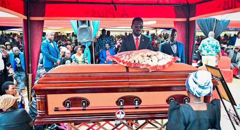 Bobi Wine lays a writh at the funeral of Joseph Nsamba