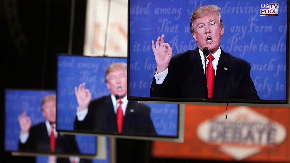 Republican U.S. presidential nominee Donald Trump is shown on TV monitors in the media filing room d