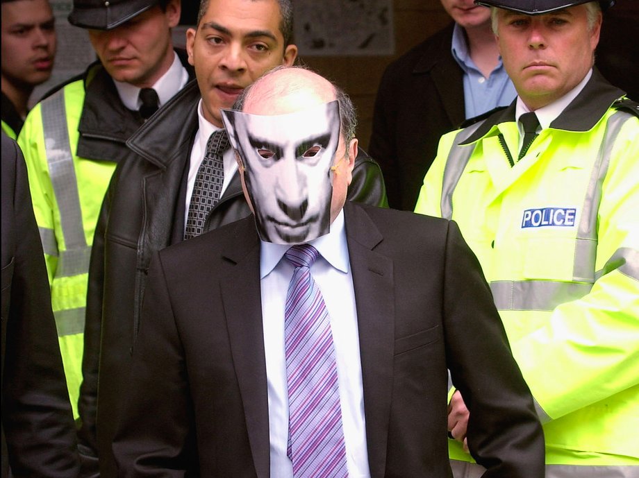 Boris Berezovsky wears a mask showing the face of Russia's President Vladimir Putin, as he leaves Bow Street Magistrates Court.