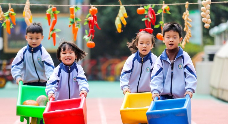 Children play games to celebrate the harvest season at a kindergarten on November 3, 2021 in Changxing County, Huzhou City, Zhejiang Province of China.