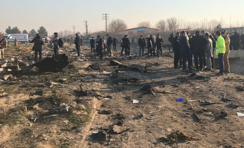 Emergency workers work near the wreckage of Ukraine International Airlines flight PS752, a Boeing 73