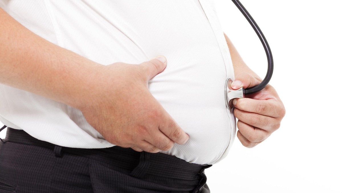 fat Man holding stethoscope for medical exam concept