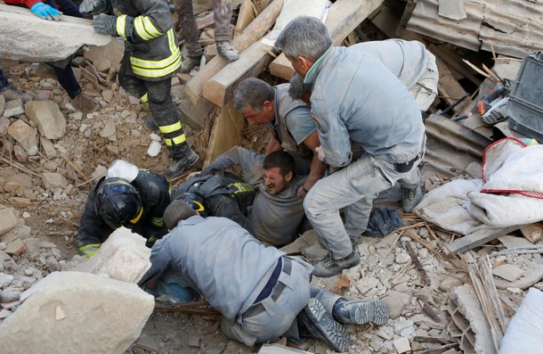 A man is rescued alive from the ruins following an earthquake in Amatrice