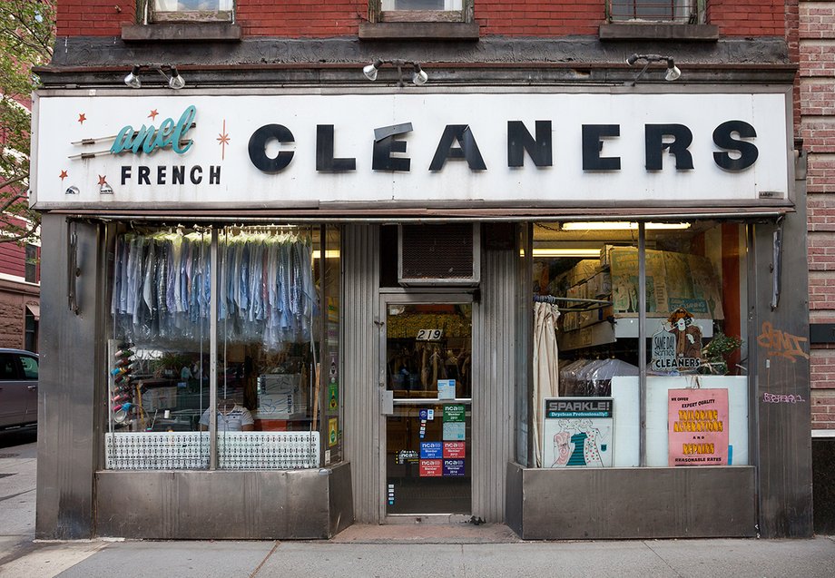 The storefronts' hand-painted and neon signs, architectural adornment, and handmade window displays attract the eye.