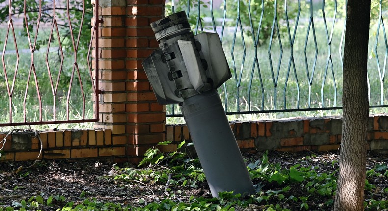 A photograph taken on July 3, 2022 shows an tail section of a 300mm rocket which appear to contained cluster bombs launched from a BM-30 Smerch multiple rocket launcher embedded in the ground after shelling in Kramatorsk, amid the Russian invasion of Ukraine.