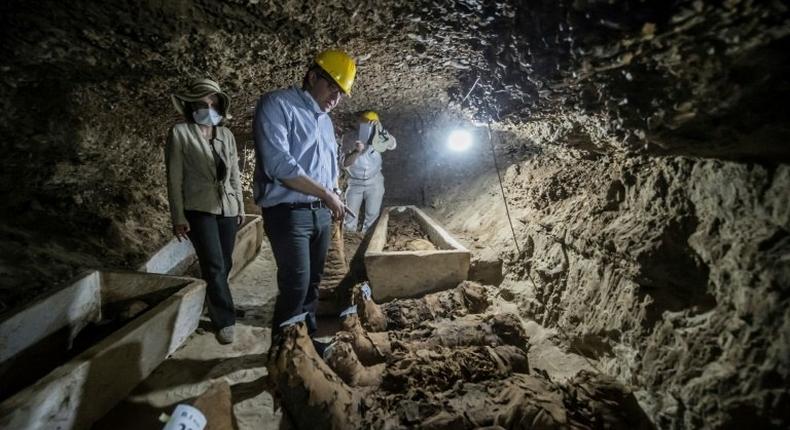 Egyptian Antiquities Minister Khaled el-Enany (C) speaks to media on May 13, 2017, in front of mummies discovered in catacombs in Touna el-Gabal district, Minya province, in central Egypt