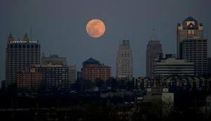 A supermoon rises behind a downtown office building in Kansas City, Missouri, in 2020.Charlie Riedel/AP