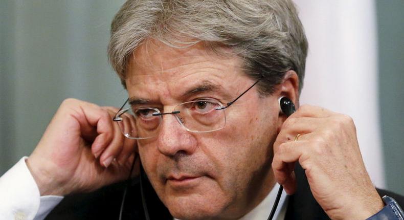 Italian Foreign Minister Paolo Gentiloni adjusts his headphones during a joint news conference with his Russian counterpart Sergei Lavrov following their meeting in Moscow, Russia, March 25, 2016. 