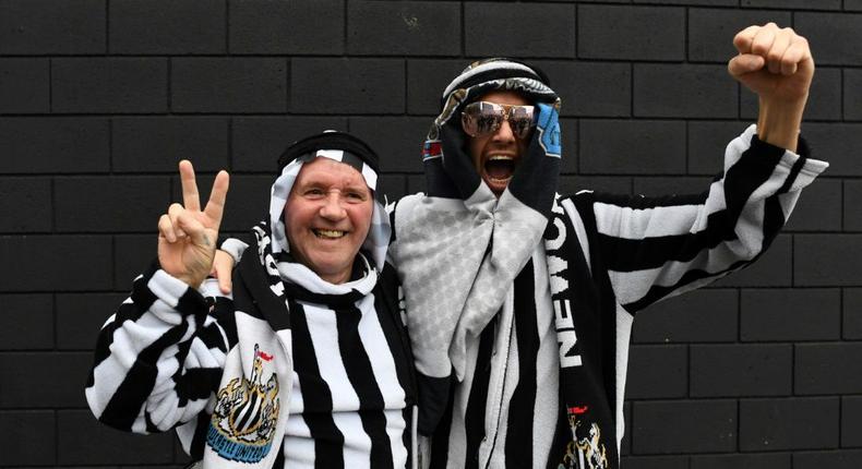 Newcastle fans pose in Arab-style clothing at St James' Park Creator: Paul ELLIS