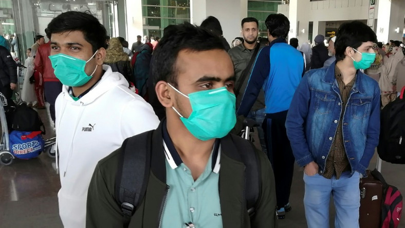 Pakistani students wearing protective face masks arriving in Islamabad from China