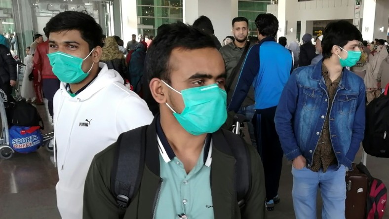 Pakistani students wearing protective face masks arriving in Islamabad from China