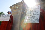 Protesters Houston and Martin hold signs against Georgia's anti-abortion heartbeat bill at Georgia State Capitol in Atlanta