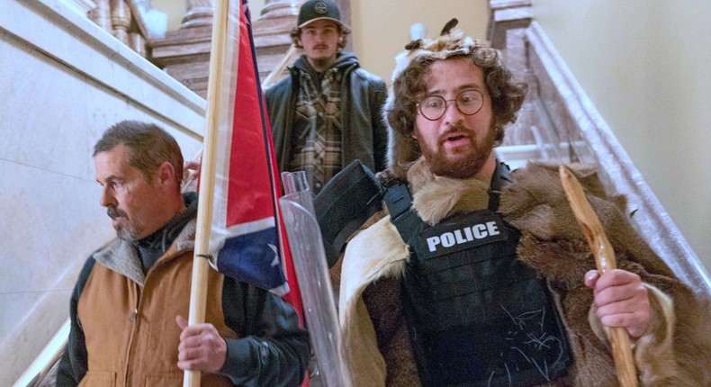 In this Jan. 6, 2021 file photo, Aaron Mostofsky, right, walk down the stairs outside the Senate Chamber in the U.S. Capitol, in Washington.