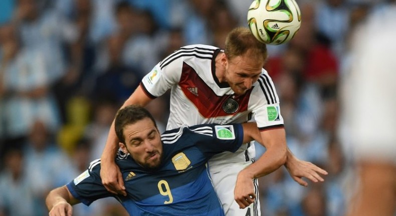 Forgotten Germany defender Benedikt Hoewedes (R), pictured here in the 2014 World Cup final, will return to Schalke on Tuesday chasing a Champions League win over his ex-club with current side Lokomotiv Moscow.