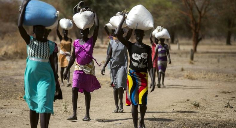 The conflict has also heavily disrupted agriculture, sparking a major food crisis. In 2017 South Sudan endured four months of famine, which affected around 100,000 people. Here, women are shown carrying food aid on their heads