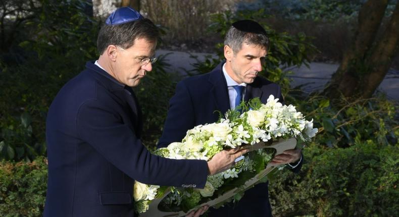 Prime Minister Marke Rutte (l) laid a wreath at the Auschwitw Never Again monument during the ceremony in Amsterdam