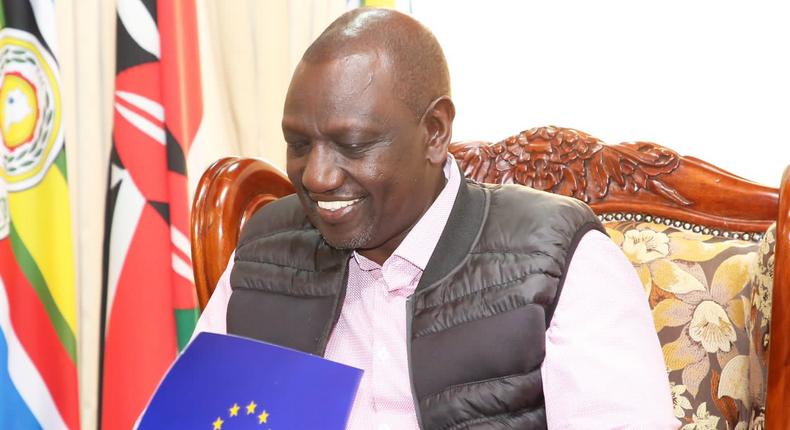 President-elect William Ruto reading a document presented by officials from the EU