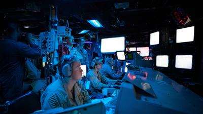 Sailors assigned to the Arleigh Burke-class guided-missile destroyer USS Carney (DDG 64) stand watch in the ship's Combat Information Center during an operation to defeat a combination of Houthi missiles and unmanned aerial vehicles, Oct. 19.US Navy photo by Mass Communication Specialist 2nd Class Aaron Lau