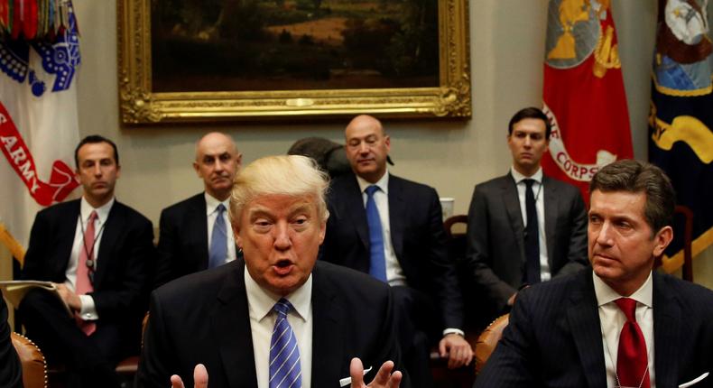 President Donald Trump hosts a meeting with business leaders in the Roosevelt Room of the White House in Washington January 23, 2017. From left are Corning CEO Wendell Weeks, Trump and Johnson & Johnson CEO Alex Gorsky.