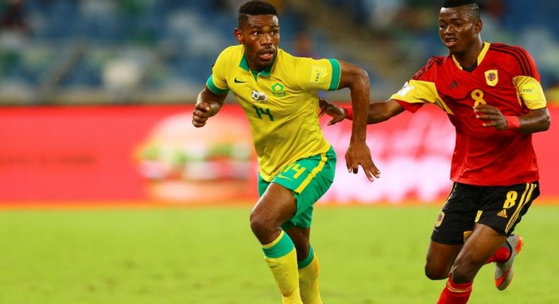 Thulani Hlatshwayo (L), captain of South African Premiership leaders Bidvest Wits FC, in action for the national team against Angola